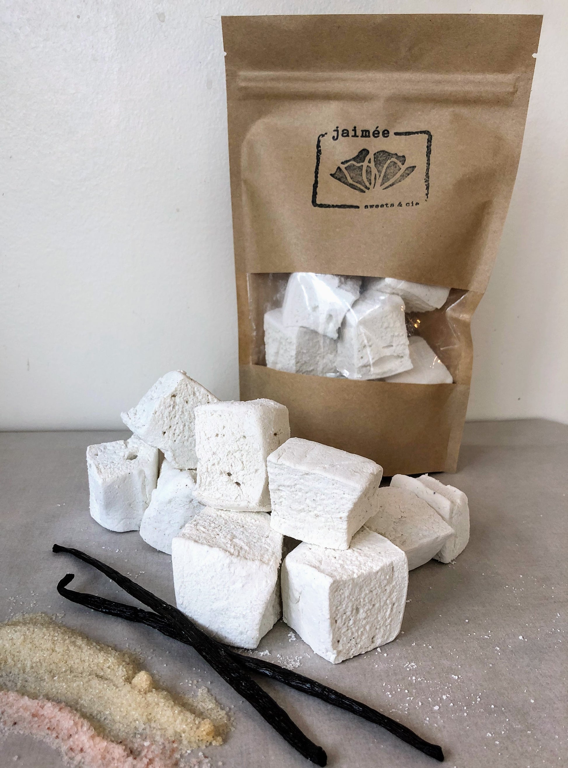 guimauves à la vanille de Madagascar ces petites bouchées de nuages doux comme un petit oreiller sous le visage. à déguster en toutes occasions.   ingrédients: sucre*, miel, gélatine*, gousse de vanille de Madagascal, sel rose  chaque paquet est d'environ 120 g.